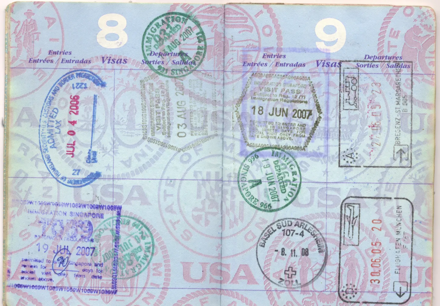 A well-traveled passport open to pages covered in overlapping visa and immigration stamps from multiple countries